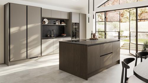 A sand grey kitchen with a slab design. It has a single wall layout with island. Black worktops and profiles also feature.