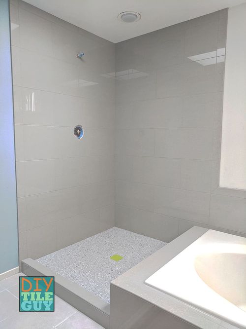 A tile shower with two walls and 12x24 tiles are installed horizontal in a 50% offset pattern