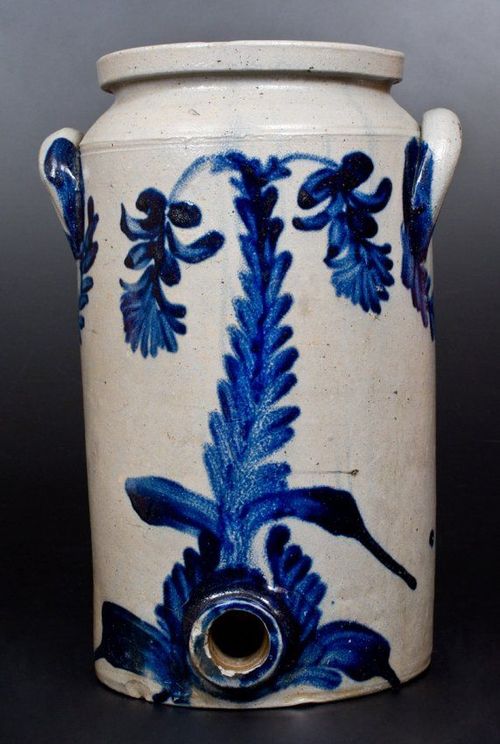 a blue and white vase sitting on top of a table