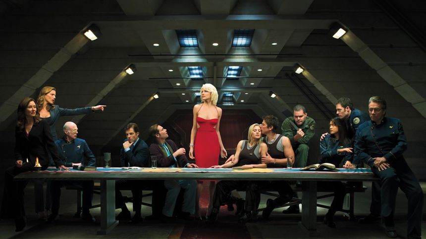 The cast of Battlestar Galactica posing in a press photo like the Last Supper