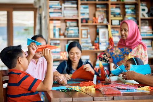 multi-generation family making wau bulan at home - malaysia wau stock pictures, royalty-free photos & images