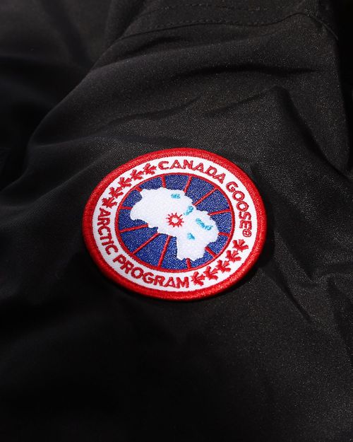 a canada goose jacket with the canadian goose logo in red, white and blue on it