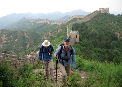 Adventurers walking along the ancient, unrestored sections of the Great Wall near Beijing
