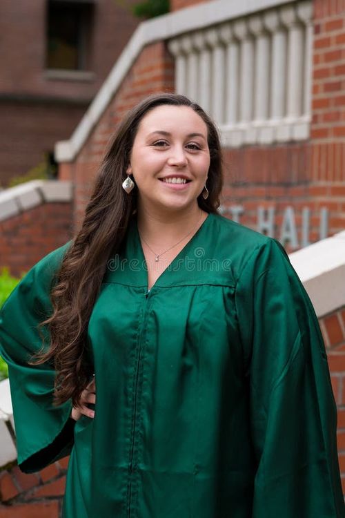 University graduate on her college campus in a cap and gown celebrating graduating from her undergrad bachelor`s degree during the Spring. Bachelor s degree stock images, royalty-free photos and pictures