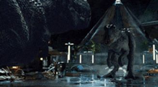 a couple of dinosaurs standing next to each other in front of a building