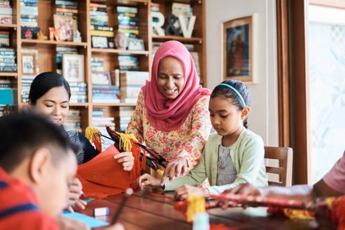 family preparing wau bulan at home - making wau stock pictures, royalty-free photos & images
