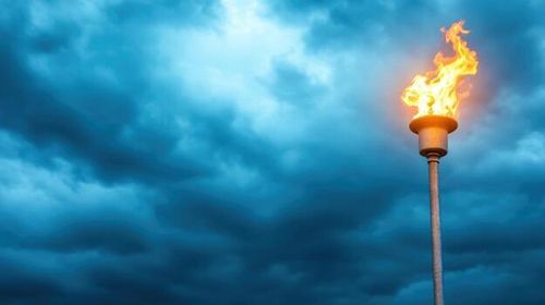 Burning torch against a cloudy sky background symbolizing hope and determination photo