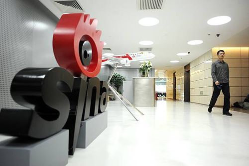Man walks past the office entrance of Sina Weibo, widely known as China's version of Twitter, in Beijing on April 16. Sina Weibo is set to go public...