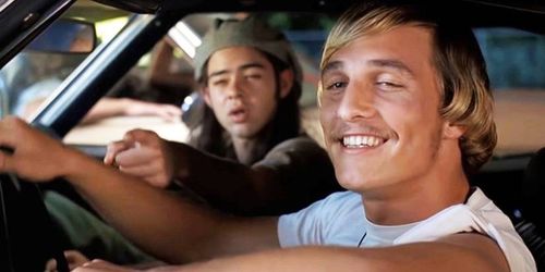 Matthew McConaughey smiling from inside a car in Dazed and Confused.