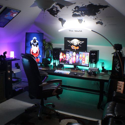 Dark attic game room with multiple monitors, colorful LED lighting, gaming chair, and wall map for immersive gaming cave ideas.