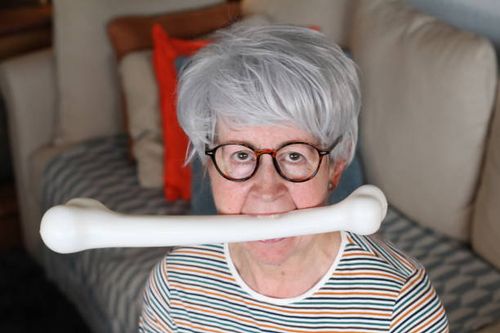 Hilarious senior woman holding bone with mouth Hilarious senior woman holding bone with mouth. diet meme stock pictures, royalty-free photos & images