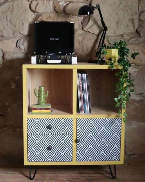 Yellow painted sideboard with geometric black and white drawer inserts and hairpin legs from @tea_at_83. Vintage record player sits on top.