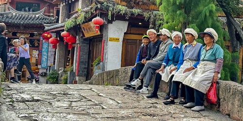 Traveler walking in Lijiang streets with canals
