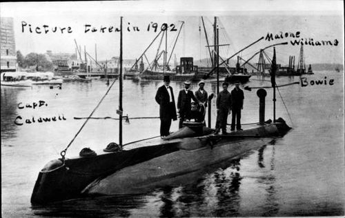 United States Navy Submarine USS Holland, SS 1, with crew, anchoring in an undisclosed naval port, date not given.