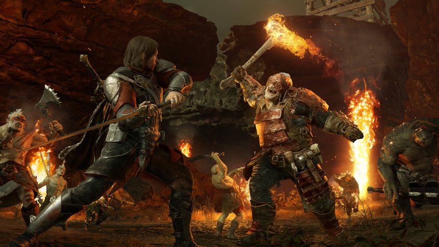 Warrior fights orc with flaming torch in fiery rocky battlefield. — Shadow Of War Picture