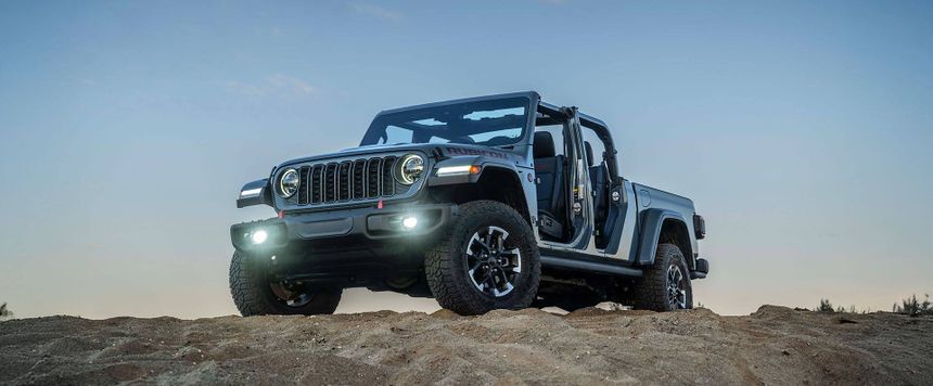 Jeep Gladiator Rubicon parked on sand dunes with doors removed showcasing open-air off-road capability in Southern California