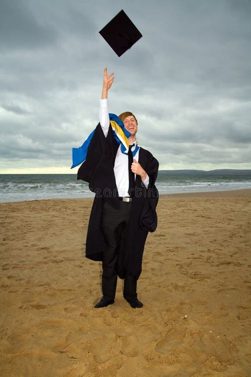 Student in cap and gown or ropes. graduate from university celebrating degree by throwing hat. male on the beach by sea. Bachelors degree stock images, royalty-free photos and pictures