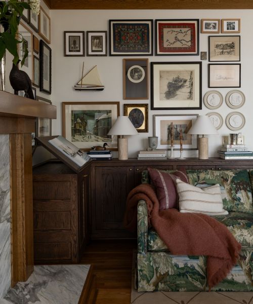 arts and crafts living room style with a patterned sofa and a vintage gallery wall