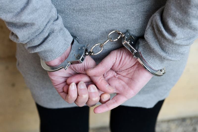 Arrested woman in handcuffs behind her back. Woman handcuff stock images, royalty-free photos and pictures