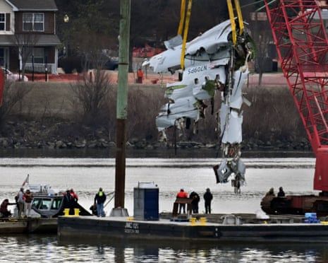 plane wreckage is lifted out of a river