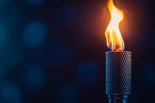 Nighttime torch flame dark bokeh background outdoor lighting photo
