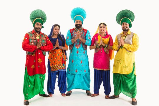 A Troupe of Punjabi Folk Dancers greeting with Namaste.