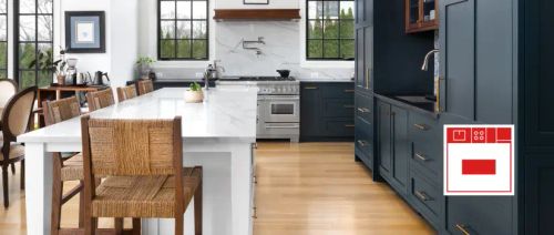 Transitional kitchen with navy blue wall cabinet unit and large white marble kitchen island.