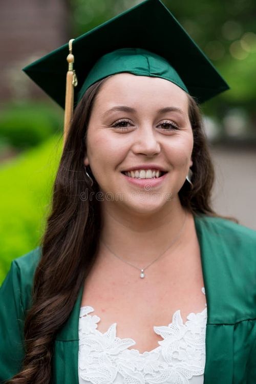 University graduate on her college campus in a cap and gown celebrating graduating from her undergrad bachelor`s degree during the Spring. Bachelor s degree stock images, royalty-free photos and pictures
