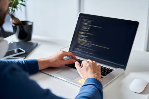 Illustration of a person coding on a laptop, representing the coding journey.