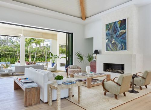white living room walls boxy modern fireplace to left beneath abstract blue and green art piece matching sageoffwhite...