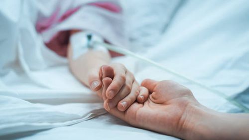 Recovering Little Child Lying in the Hospital Bed Sleeping, Mother Holds Her Hand Comforting. Focus on the Hands. Emotional Family Moment. Recovering Little Child Lying in the Hospital Bed Sleeping, Mother Holds Her Hand Comforting. Focus on the Hands. Emotional Family Moment. sick people stock pictures, royalty-free photos & images