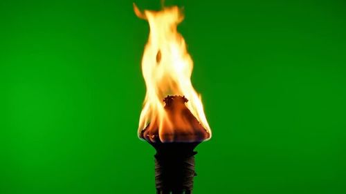 Blazing Torch: An illuminating torch, its vibrant flames dancing against a stark backdrop, symbolizes enlightenment, passion, and the eternal flame.