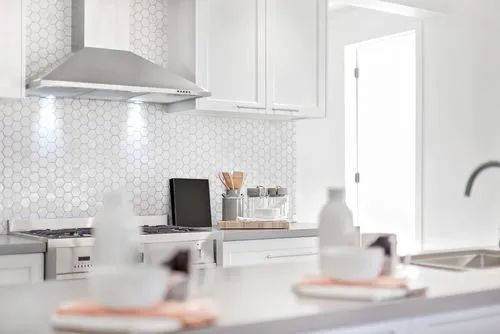 Simple plain white kitchen with penny style kitchen wall tiles design