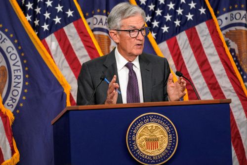 arafed image of a man in a suit and tie speaking at a podium