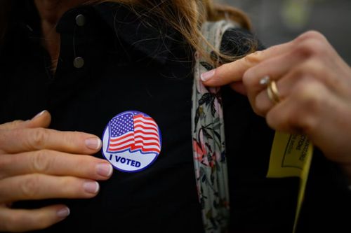 A voter puts on an "I Voted" sticker after dropping off her ballot in West Chester, Pennsylvania, on Nov. 5, 2024. (Kriston Jae Bethel for Votebeat)