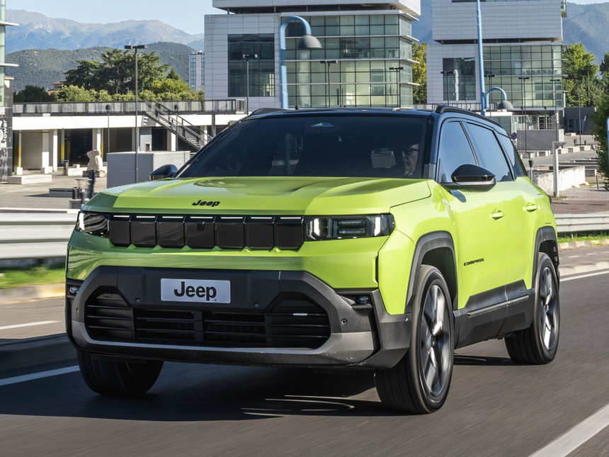 Lime green Jeep Compass driving in an urban setting showcasing modern SUV design in Southern California