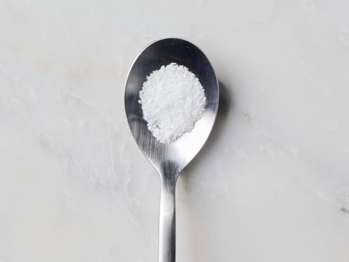 overhead shot of a gram of salt on a spoon