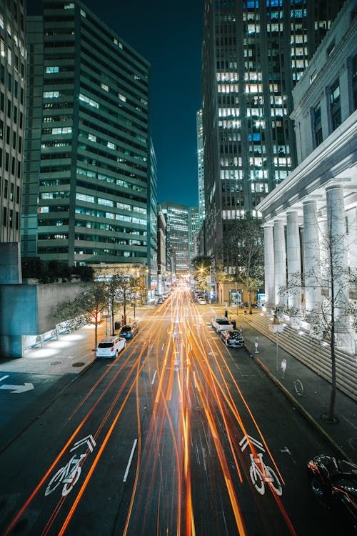 Free Dynamic night shot of San Francisco cityscape featuring light trails along urban streets. Stock Photo