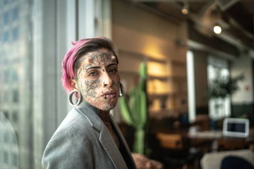 portrait of mid adult businesswoman at office - tatto piercing stock pictures, royalty-free photos & images
