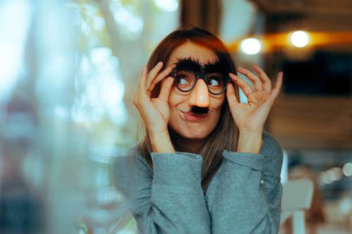 Funny Woman Wearing Silly Moustache Party Accessories Glasses Girl with a sense of humor using disguise eyeglasses for a prank woman facial hair stock pictures, royalty-free photos & images