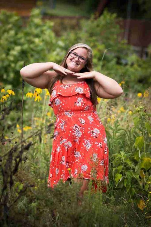 A cute girl pose with a girl with hands under her chin