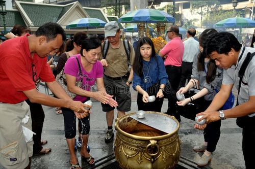 A group of Thai people washing their hands with holy water before offering their prayers at the Erawan Shrine on Thanon Ratchadamri in Bangkok, Thailand. Thai people stock images, royalty-free photos and pictures