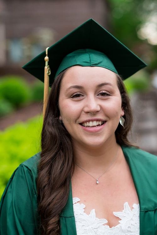 University graduate on her college campus in a cap and gown celebrating graduating from her undergrad bachelor`s degree during the Spring. Bachelor s degree stock images, royalty-free photos and pictures