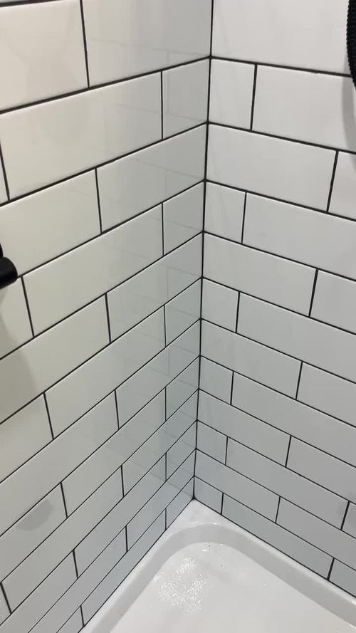 White subway tile paired with black fixtures & black grout is such a timeless look! #bathroomdesign #longislandcontractor