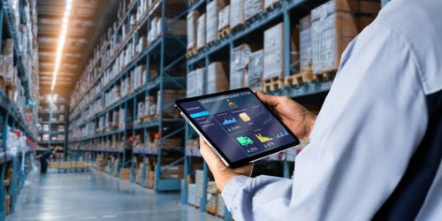 Smart Warehouse,Inventory management system concept. Manager using digital tablet,showing warehouse software management dashboard on blurred warehouse as background importing stock pictures, royalty-free photos & images