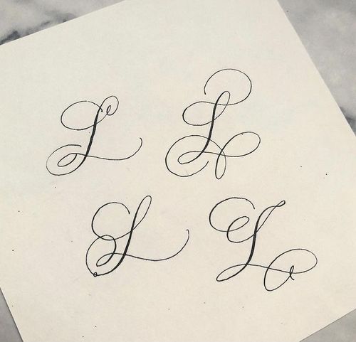 the letters l, f, and h are written in cursive writing on paper