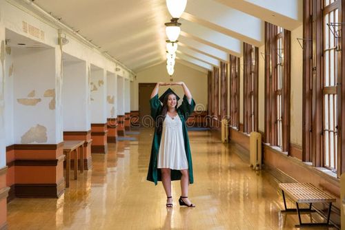 University graduate on her college campus in a cap and gown celebrating graduating from her undergrad bachelor`s degree during the Spring. Bachelor s degree stock images, royalty-free photos and pictures