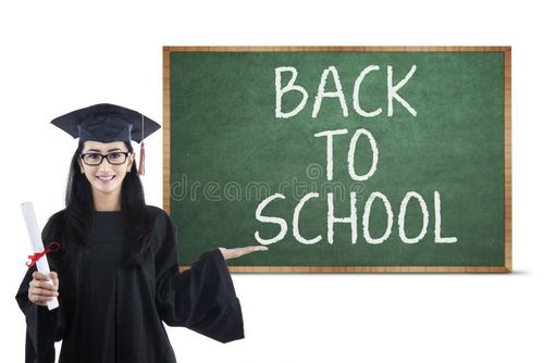 Young graduate is holding certificate in classroom showing back to school text. Bachelor degree stock images, royalty-free photos and pictures