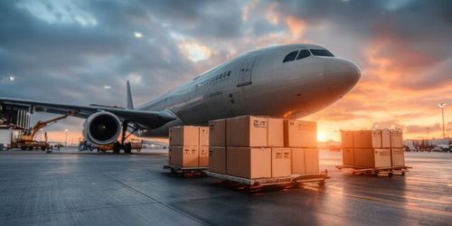 Aerial View of Large Cargo Plane at Airport Terminal During Sunset, Showcasing Air Freight Logistics