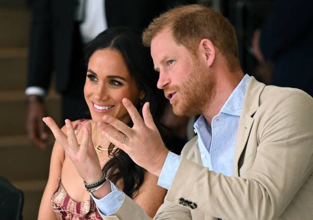 Britain's Prince Harry , Duke of Sussex, speaks with his wife Meghan Markle while attending a show during a visit to the National Centre for the Arts...